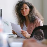 confident businesswoman reviewing documents in modern office