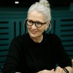 elderly woman with gray hair wearing eyeglasses